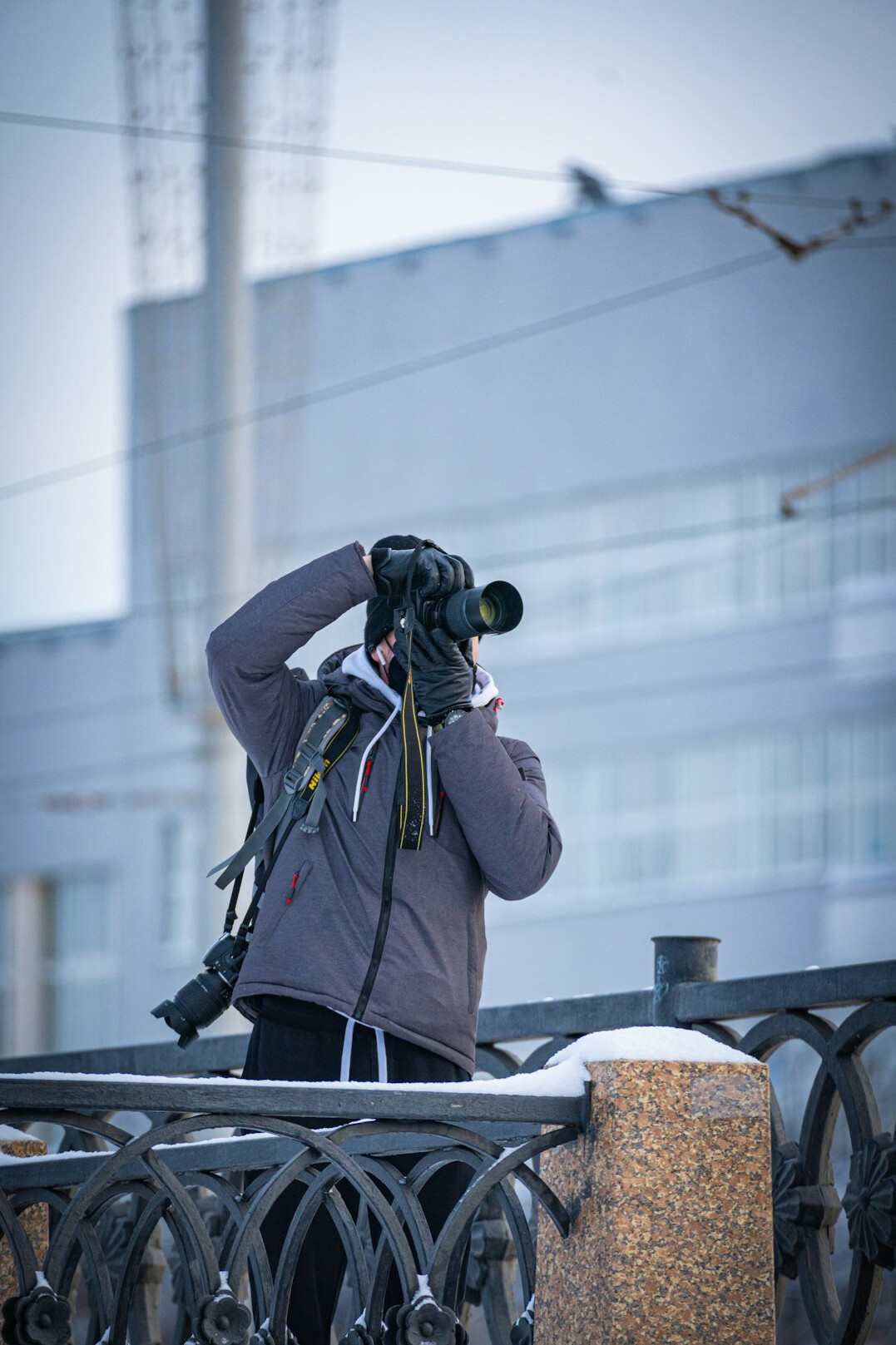 Camera operator filming a live outdoor news broadcast