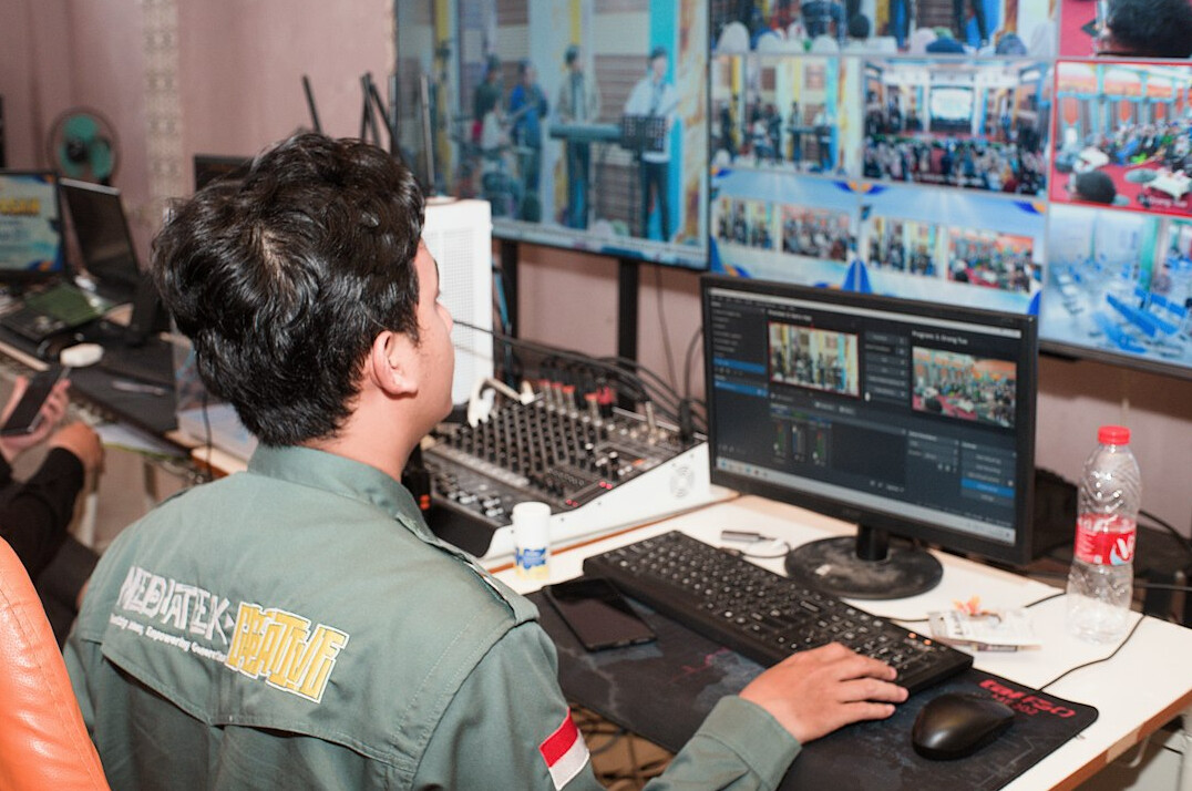 Wide view of a television studio control room with switchers